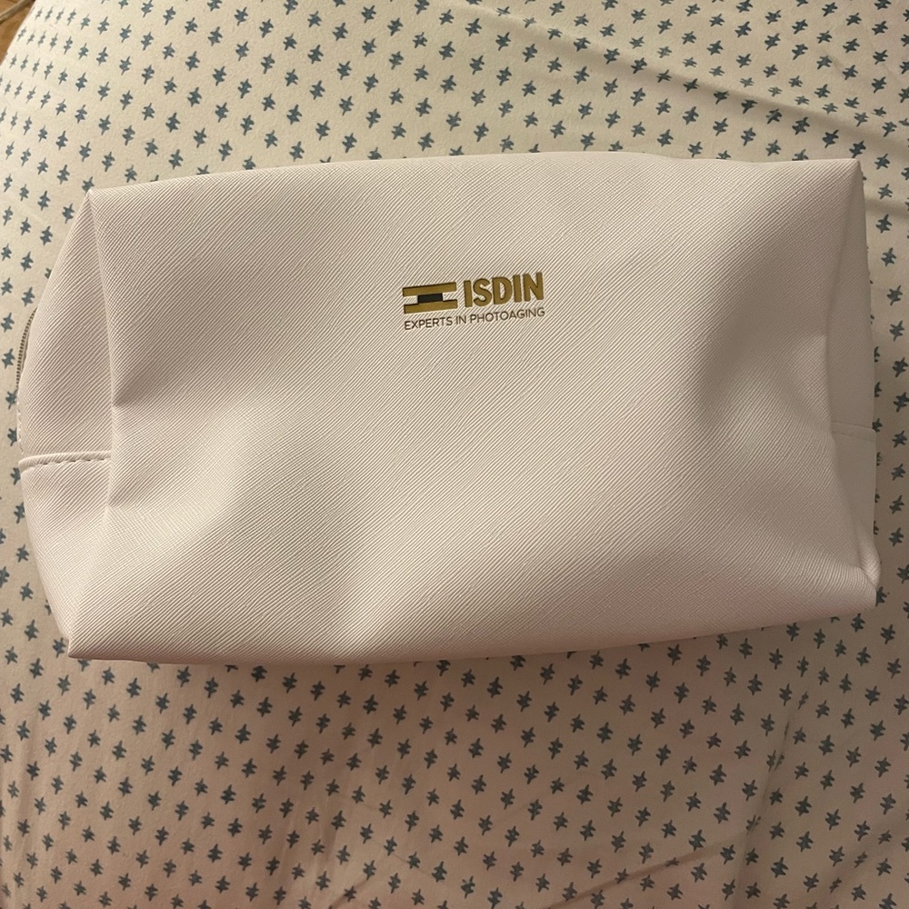 White cosmetic pouch with gold zipper